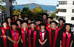 Doctoral graduates with Rangitoto in the background